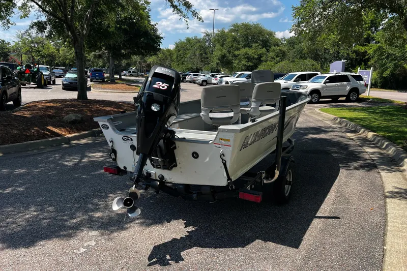 Slide: The Image of 2012 Alumacraft Fisherman 160 Tiller boat on trailer in parking lot. - 6