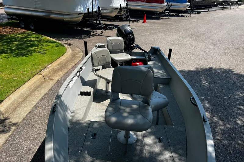 Slide: The Image of 2012 Alumacraft Fisherman 160 Tiller boat with seating, parked on pavement. - 5
