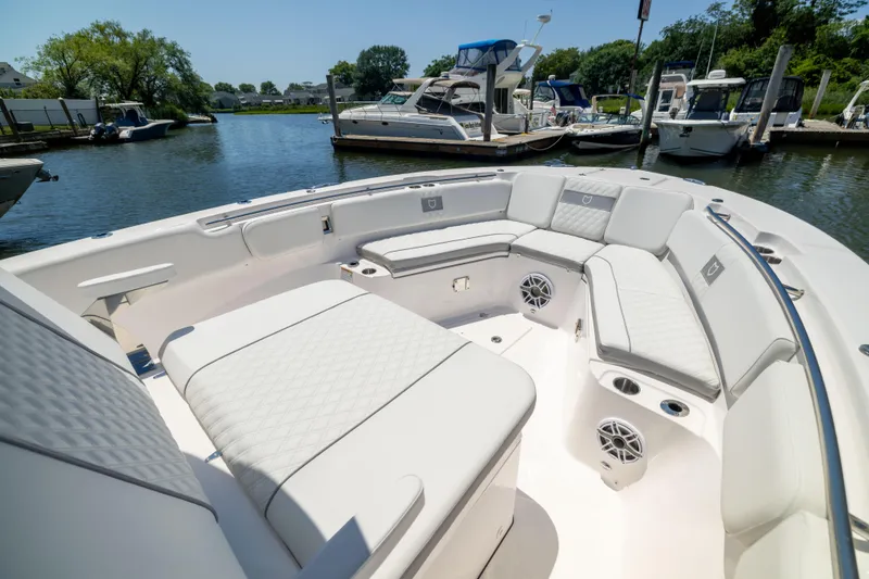 Slide: The Image of The image shows the spacious bow area of a Sea Fox 328 Commander with luxurious seating. - 44