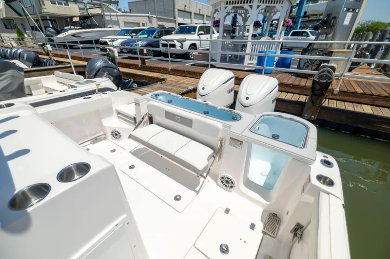 Slide: The Image of The image shows the stern of a Sea Fox 328 Commander with dual engines and a seating area. - 15