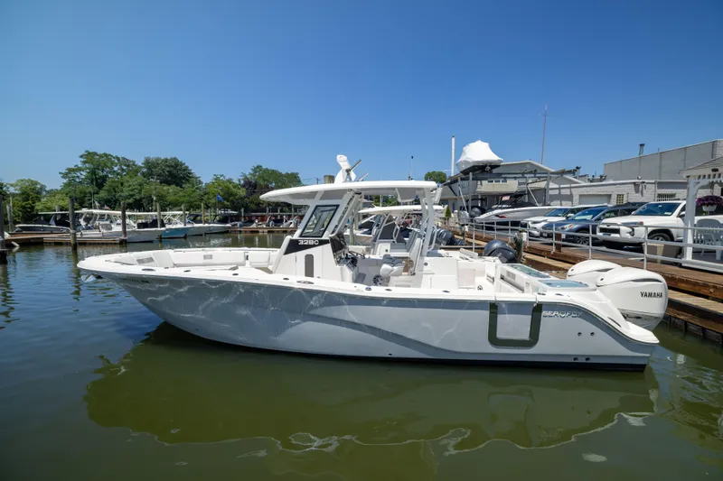 Slide: The Image of A 2027 Sea Fox 328 Commander is docked on the water. - 1
