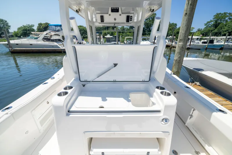 Slide: The Image of The image shows the cockpit of a Sea Fox 328 Commander boat at a marina. - 10