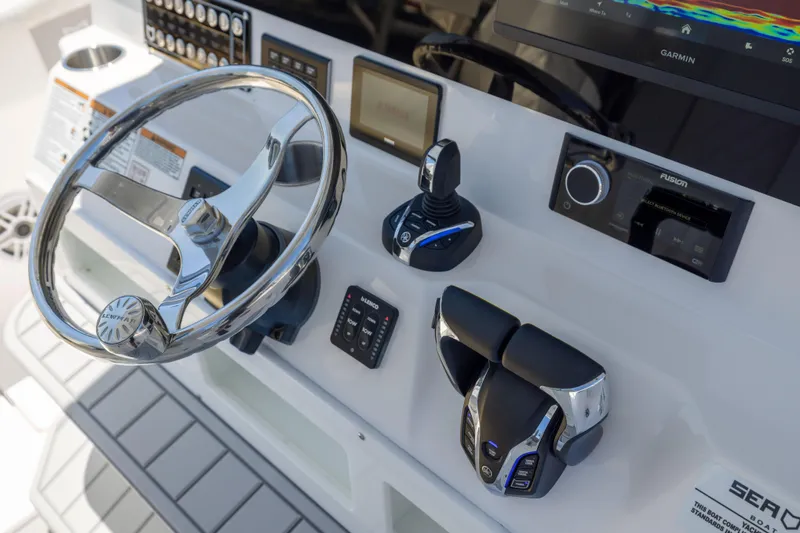Slide: The Image of The image shows the helm of a Sea Fox 328 Commander with modern controls and displays. - 33