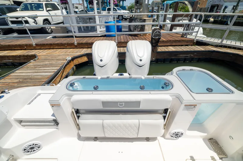 Slide: The Image of The image shows the stern of a Sea Fox 328 Commander with twin outboard engines and a livewell. - 19