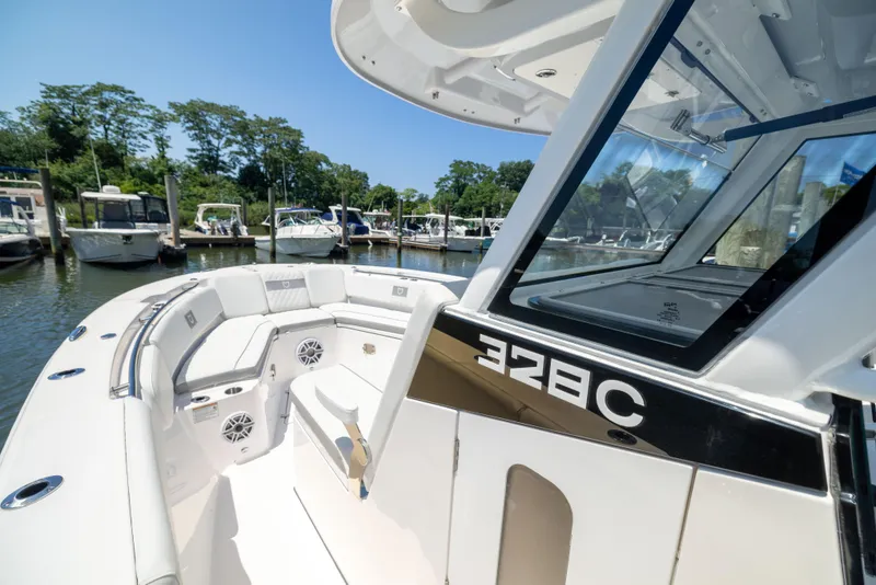 Slide: The Image of The image shows a modern boat with white interior and sleek lines docked at a marina. - 42