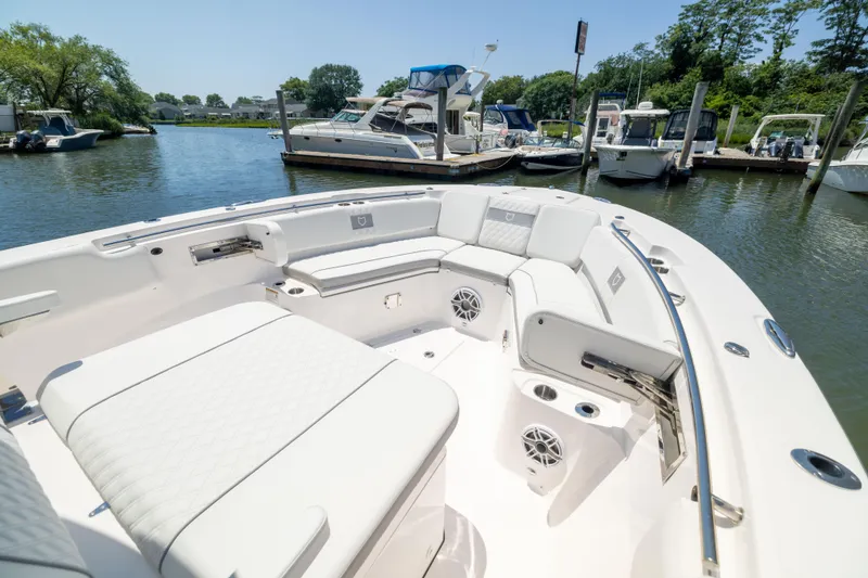 Slide: The Image of The image shows the spacious cockpit of a Sea Fox 328 Commander boat in a marina. - 46