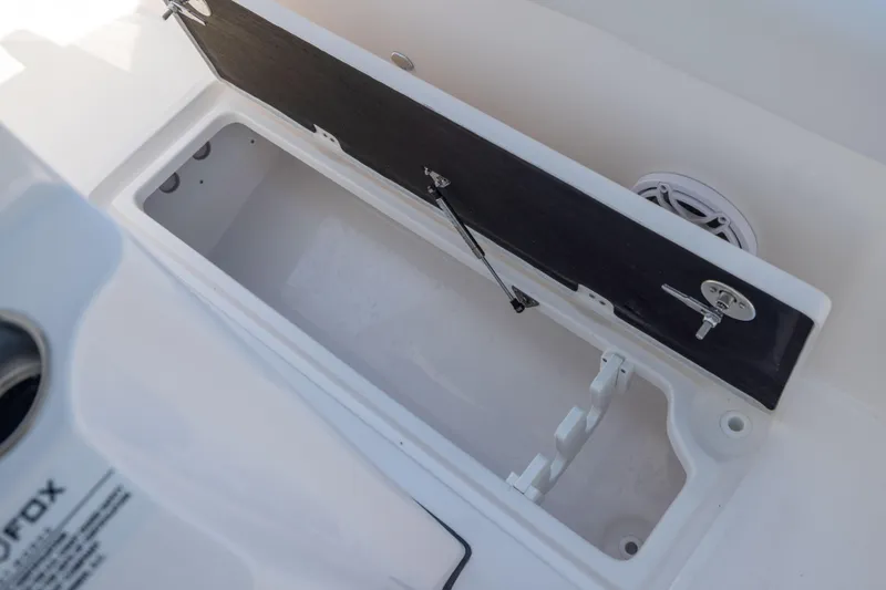 Slide: The Image of An open storage compartment on a Sea Fox 328 Commander boat, with a speaker nearby. - 39