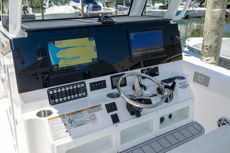 Slide: The Image of The image shows the helm of a Sea Fox 328 Commander with two screens and a steering wheel. - 28