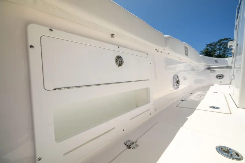 Slide: The Image of The image shows the deck of a Sea Fox 328 Commander boat with storage and speakers. - 26