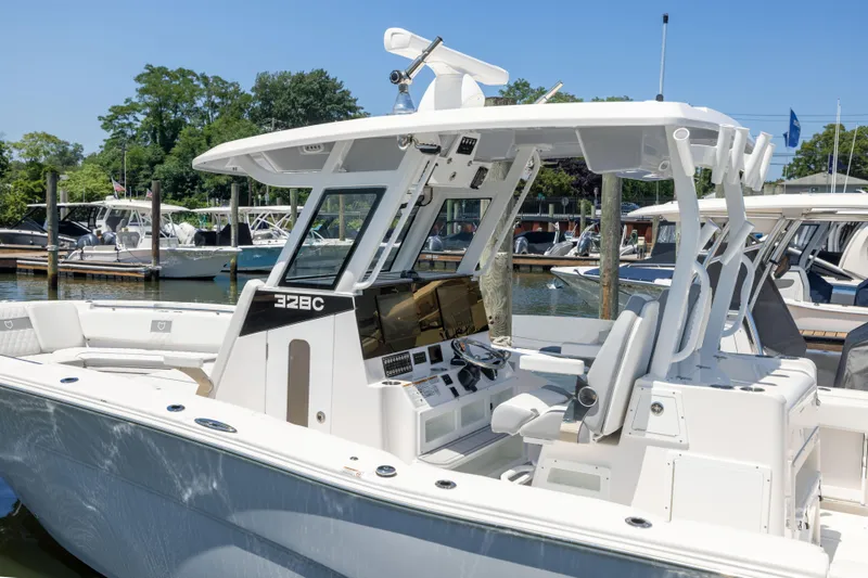 Slide: The Image of A modern, white Sea Fox 328 Commander with a spacious cockpit docked at the marina. - 2