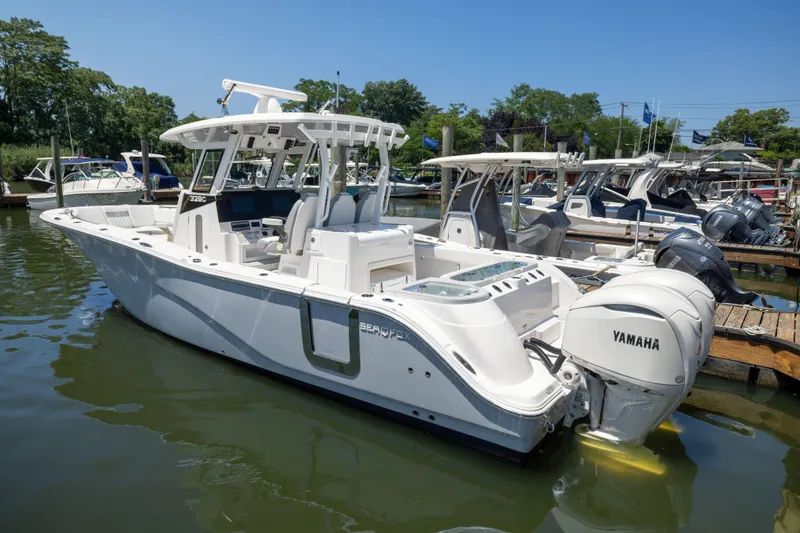 Slide: The Image of A 2027 Sea Fox 328 Commander is docked in the water, surrounded by other boats. - 3