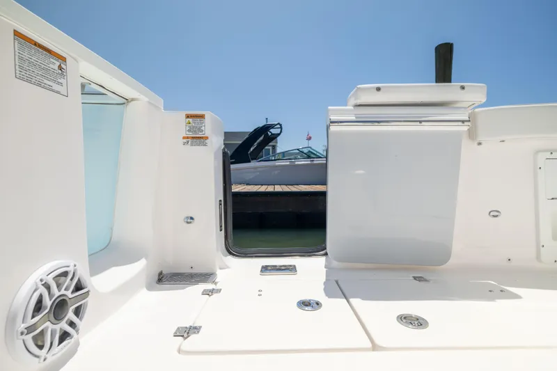 Slide: The Image of View of a Sea Fox 328 Commander cockpit with an open door and a boat in the background. - 8