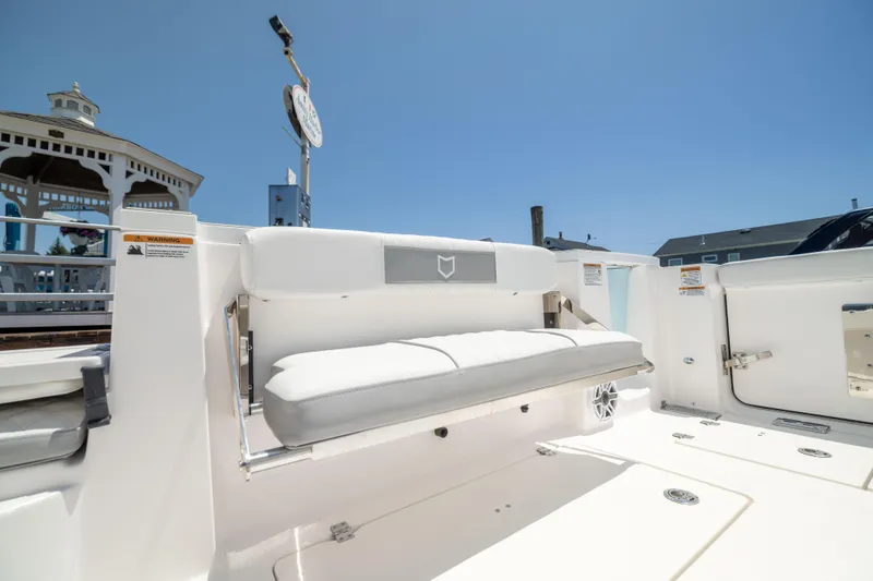 Slide: The Image of The 2027 Sea Fox 328 Commander features a white, cushioned outdoor bench seat. - 13