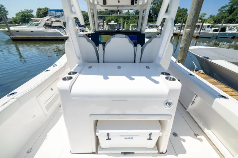 Slide: The Image of The image shows the cockpit of a Sea Fox 328 Commander boat at a marina. - 9