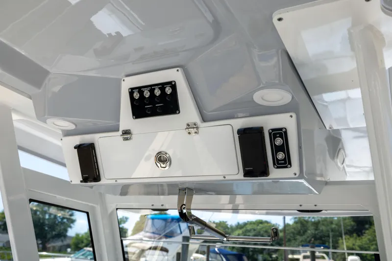 Slide: The Image of The image shows the helm of a 2027 Sea Fox 328 Commander with controls and speakers. - 34