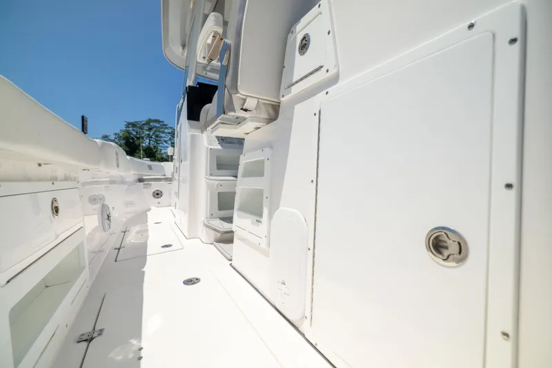 Slide: The Image of The image shows the deck of a Sea Fox 328 Commander boat with white storage compartments. - 24