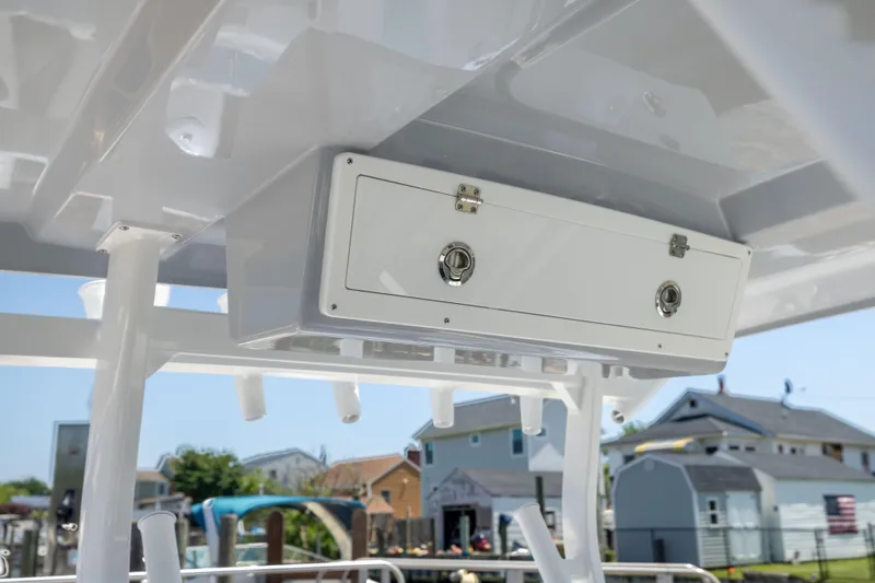 Slide: The Image of A white boat with a storage compartment under the roof, surrounded by houses. - 35