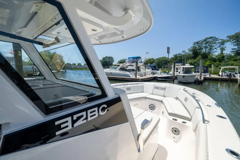 Slide: The Image of The image shows a modern boat docked, featuring a spacious deck and luxurious seating. - 43