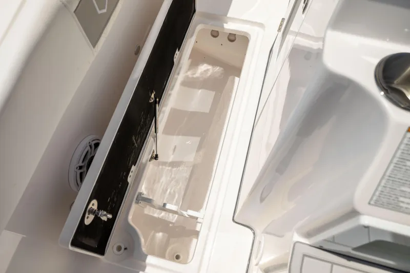 Slide: The Image of An open storage compartment on a boat with white surfaces and a speaker. - 41