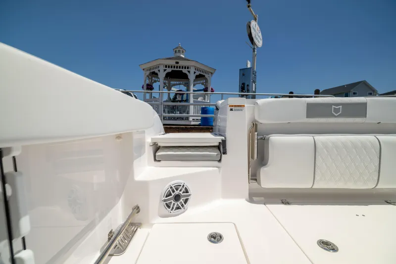 Slide: The Image of The image shows the deck of a Sea Fox 328 Commander with a gazebo in the background. - 6
