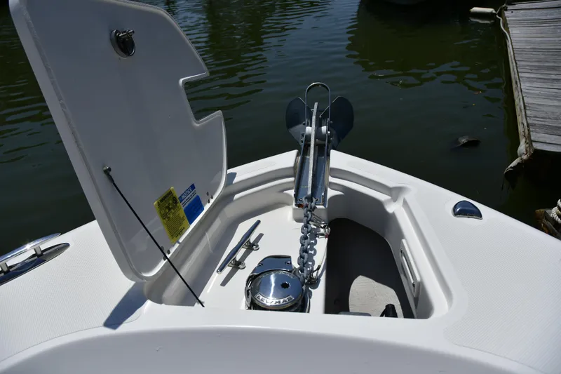 Slide: The Image of 2020 Pursuit C 238 Center Console boat anchor compartment with open hatch. - 17