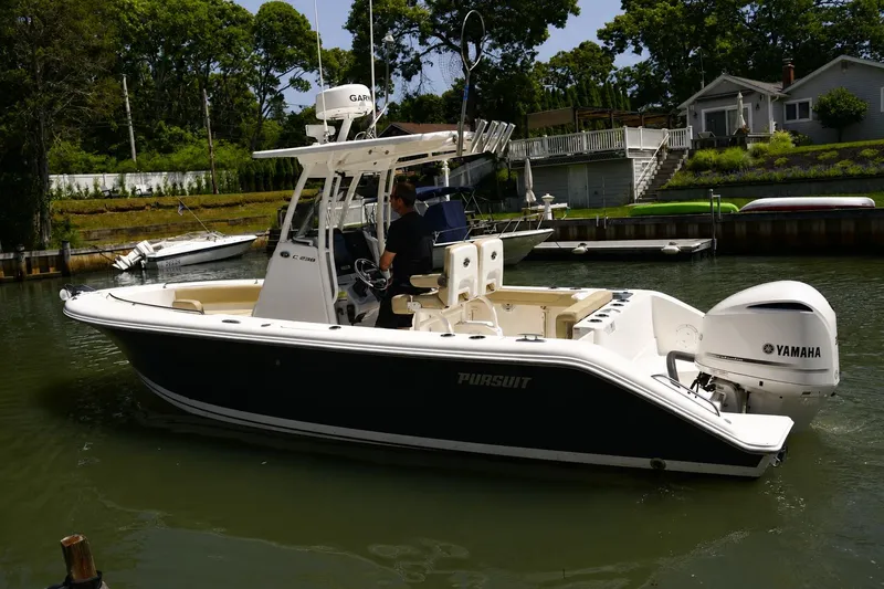 Slide: The Image of 2020 Pursuit C 238 Center Console boat with Yamaha engine on a calm waterway. - 3