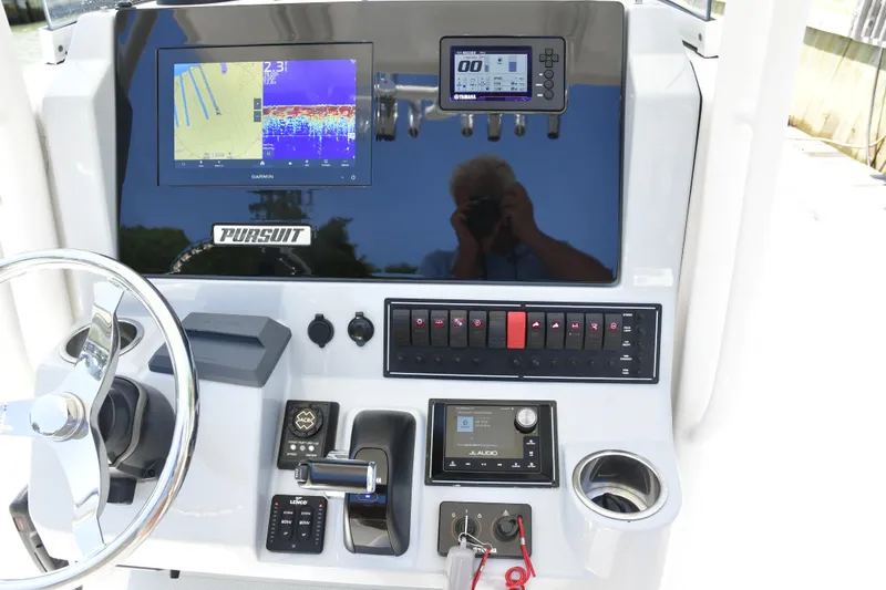 Slide: The Image of 2020 Pursuit C 238 Center Console dashboard with navigation and control systems. - 11