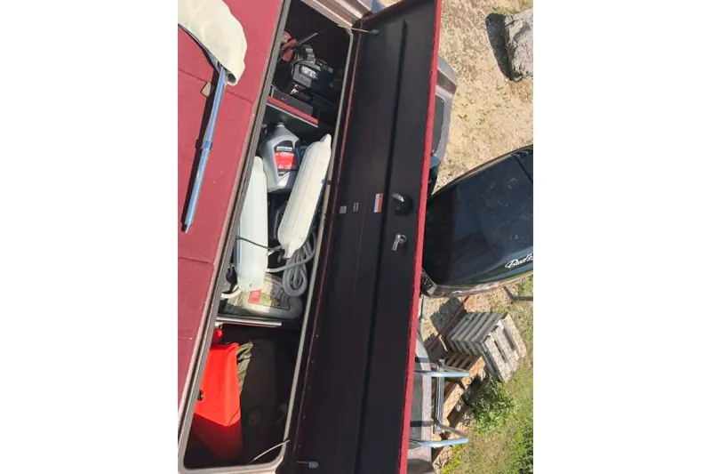 Slide: The Image of Storage compartment of a 1996 Astro 20fsx boat with various boating supplies. - 6