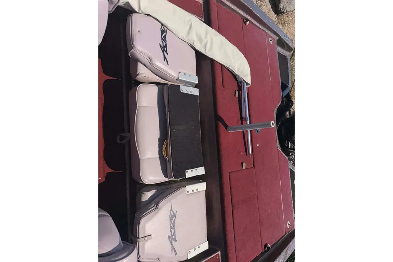 Slide: The Image of 1996 Astro 20fsx boat interior with red carpet and cushioned seats. - 9