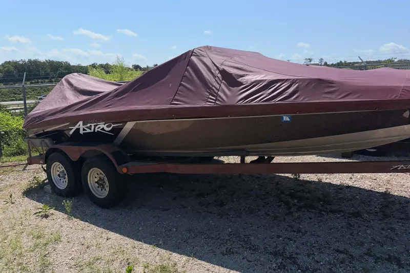 The Image of Covered 1996 Astro 20fsx boat on trailer, parked outdoors on gravel. - 0