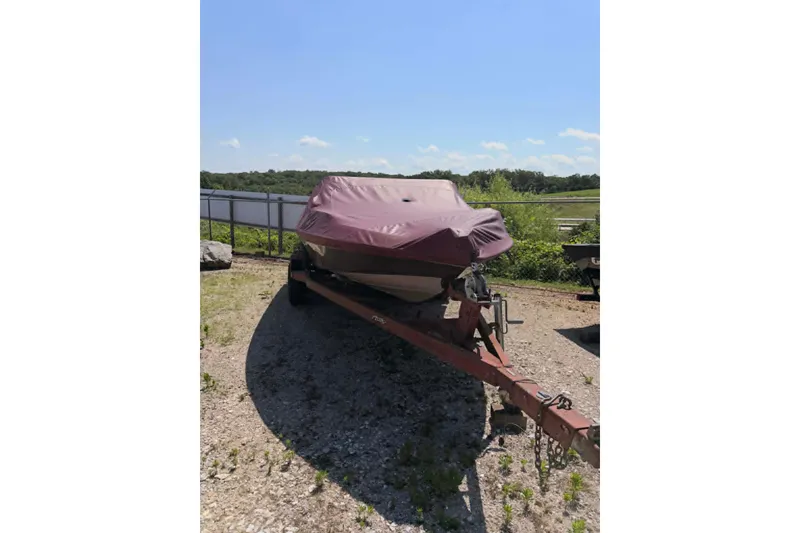 Slide: The Image of Covered 1996 Astro 20fsx boat on trailer, parked outdoors under clear sky. - 2