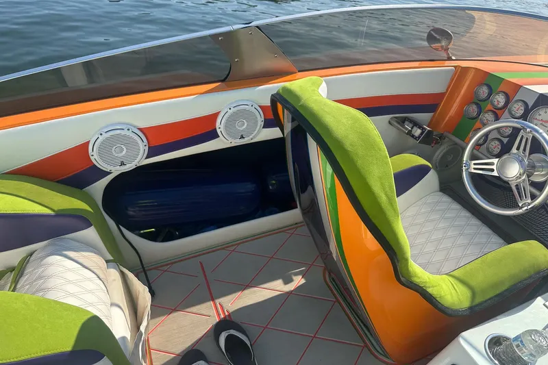 Slide: The Image of Vibrant Skater 46 boat interior with green seats and colorful dashboard, 2013 model. - 9