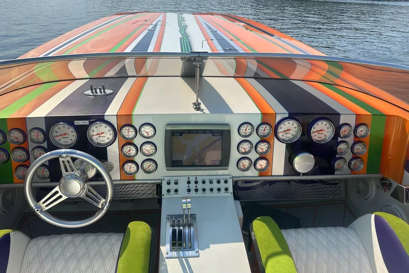 Slide: The Image of Colorful dashboard of a 2013 Skater 46 boat with multiple gauges and steering wheel. - 8