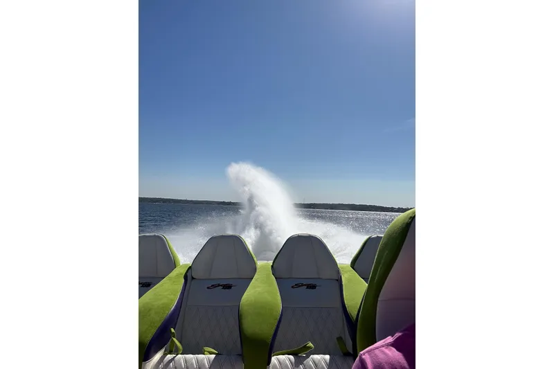 Slide: The Image of High-speed Skater 46 boat on water, 2013 model, with vibrant green seats and wake trail. - 15