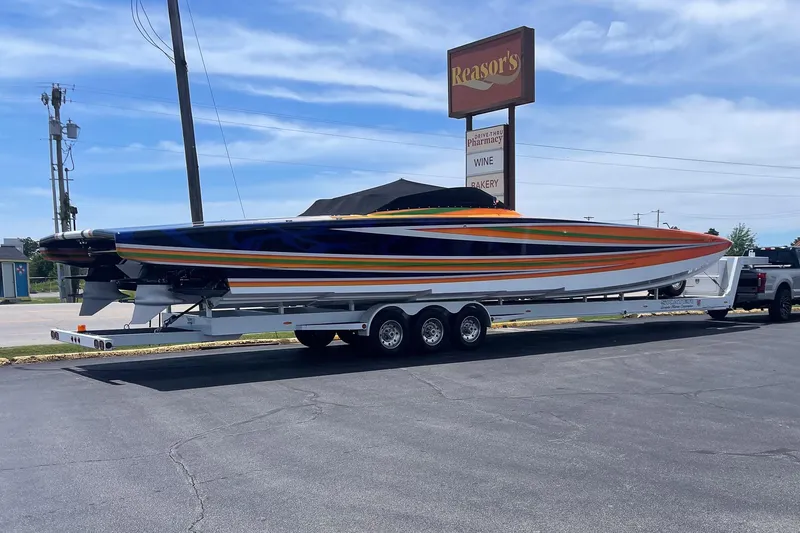 Slide: The Image of Colorful 2013 Skater 46 speedboat on trailer in parking lot near Reasor's sign. - 3