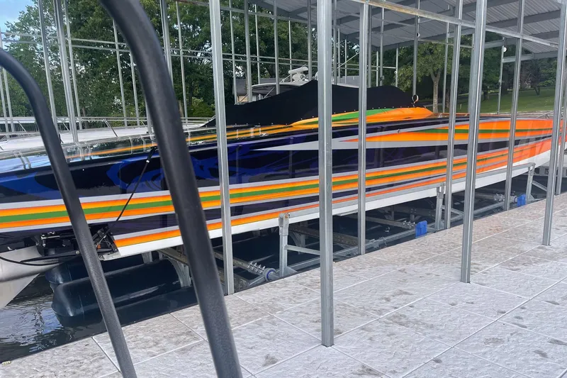 Slide: The Image of Colorful 2013 Skater 46 boat docked in a marina with vibrant stripes. - 5