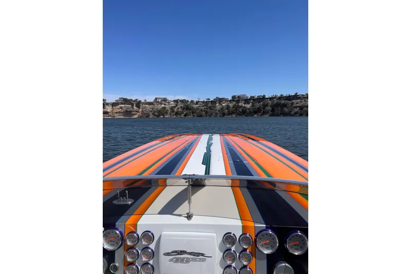 Slide: The Image of Colorful 2013 Skater 46 speedboat on a lake with scenic shoreline view. - 6