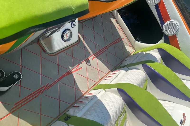 Slide: The Image of Interior of a 2013 Skater 46 boat with vibrant green and white seating. - 11