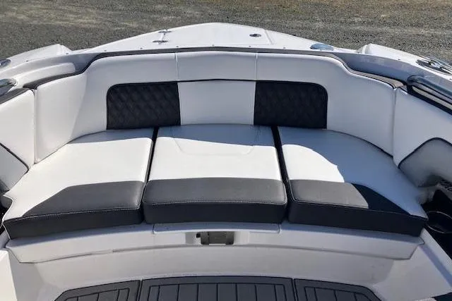 Slide: The Image of 2024 Monterey M-65 boat seating with black and white cushioned upholstery. - 19