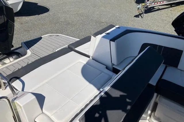 Slide: The Image of 2024 Monterey M-65 boat interior with sleek white and black seating design. - 9