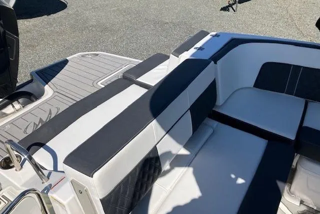 Slide: The Image of 2024 Monterey M-65 boat interior with sleek white and black seating design. - 10