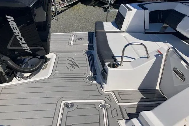 Slide: The Image of 2024 Monterey M-65 boat deck with Mercury engine, featuring sleek seating and modern design. - 4
