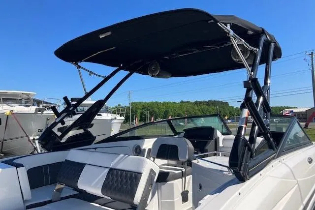 Slide: The Image of 2024 Monterey M-65 boat with sleek design and spacious seating under a sunny sky. - 6