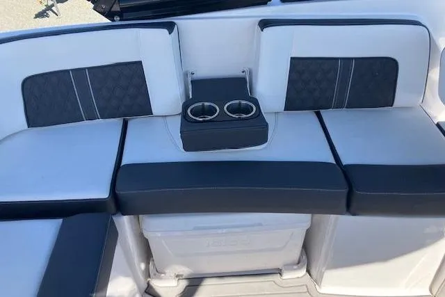 Slide: The Image of 2024 Monterey M-65 boat seating with cup holders, featuring stylish black and white upholstery. - 12