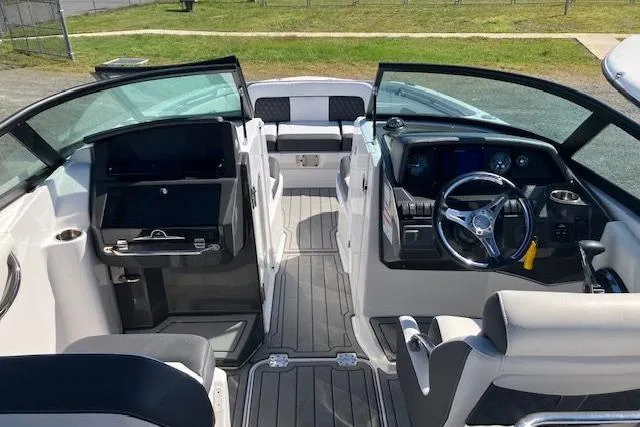 Slide: The Image of 2024 Monterey M-65 boat interior with modern dashboard and seating. - 18