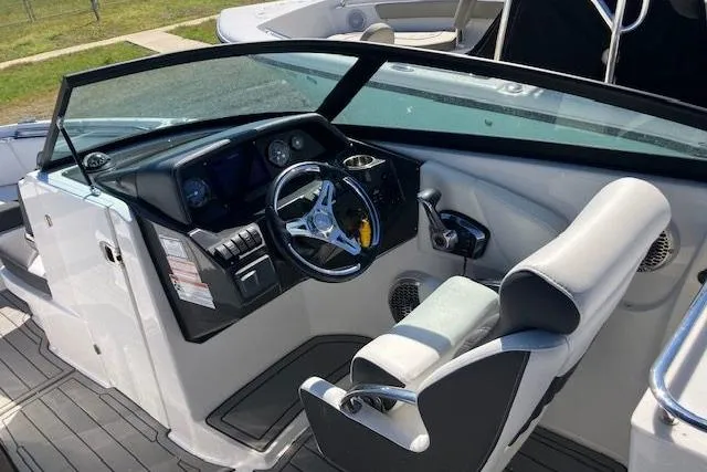 Slide: The Image of 2024 Monterey M-65 boat cockpit with modern steering wheel and dashboard controls. - 17