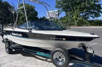 The Image of 1996 MasterCraft ProStar 190 boat on trailer, parked outdoors. - 1