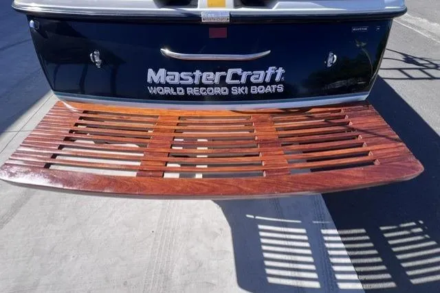 Slide: The Image of 1996 MasterCraft ProStar 190 boat with wooden swim platform, showcasing "World Record Ski Boats" branding. - 8