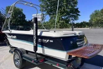 Slide: The Image of 1996 MasterCraft ProStar 190 boat on trailer, featuring sleek design and wooden swim platform. - 4