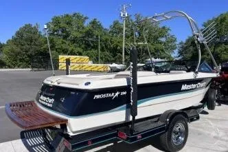 Slide: The Image of 1996 MasterCraft ProStar 190 boat on trailer, parked outdoors, with wakeboard tower. - 5